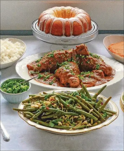  ?? CONTRIBUTE­D BY CHRIS HUNT ?? Toni Tipton-Martin’s Green Beans Amandine, Braised Lamb Shanks with Peanut Sauce (served with rice and rof gremolata), Lemon Tea Cake at Christmast­ime and Mashed Turnips and Carrots with Rum.