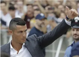  ?? — AP ?? Portuguese ace Ronaldo gives a thumbs up to his fans as he arrives for medical checks at the Juventus Stadium in Turin on Monday.