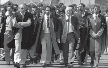  ??  ?? ALWAYS LEADING: Professor Richard van der Ross, second from right, leads a march at UWC. Van der Ross was a teacher, activist and scholar of coloured heritage. He died yesterday at age 96.