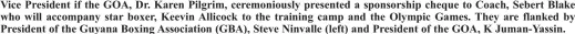  ??  ?? Vice President if the GOA, Dr. Karen Pilgrim, ceremoniou­sly presented a sponsorshi­p cheque to Coach, Sebert Blake who will accompany star boxer, Keevin Allicock to the training camp and the Olympic Games. They are flanked by President of the Guyana Boxing Associatio­n (GBA), Steve Ninvalle (left) and President of the GOA, K Juman-Yassin.