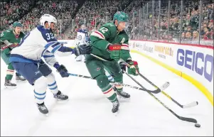  ?? AP PHOTO/ANDY CLAYTON-KING ?? Minnesota Wild centre Eric Staal (12) controls the puck in front of Winnipeg Jets defenceman Dustin Byfuglien (33) in the first period of an NHL playoff game Sunday in St. Paul, Minn.