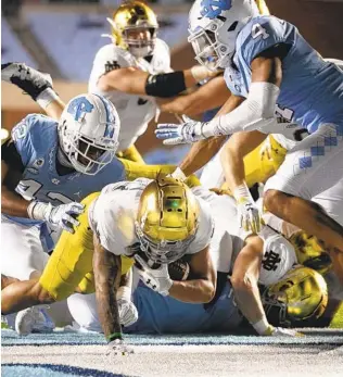  ?? ROBERT WILLETT AP ?? Notre Dame's Kyren Williams (23) scores on a 1-yard carry in a 31-17 win against North Carolina on Friday in Chapel Hill, N.C. Williams finished with 124 yards and two total touchdowns.