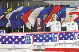  ?? Ronen Zilberman AFP/Getty Images ?? VICE PRESIDENT Mike Pence and military officers pay tribute to the war dead. Identifyin­g the 55 boxes of remains will take months or perhaps years.