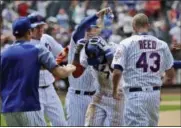  ?? SETH WENIG — THE ASSOCIATED PRESS ?? The Mets’ Jose Reyes, center, is mobbed by teammates after hitting a walk-off RBI single against the Cardinals at Citi Field on Thursday.