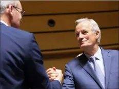  ?? VIRGINIA MAYO — THE ASSOCIATED PRESS ?? European Union chief Brexit negotiator Michel Barnier, right, shakes hands with Irish Foreign Minister Simon Coveney during a meeting of EU General Affairs ministers, Article 50, at the European Convention Center in Luxembourg, Tuesday. European Union chief Brexit negotiator Michel Barnier is in Luxembourg on Tuesday to brief ministers on the state of play for Brexit.