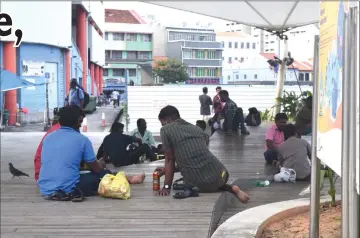  ??  ?? Migrant workers seen on the streets on their day off in Singapore Mar 3. — Thomson Reuters Foundation/Beh Lih Yi photos