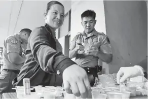  ??  ?? SURPRISE DRUG TEST – A female jail officer submits her urine sample during yesterday’s surprise drug test conducted alongside the 3rd Quarter Management Conference of the Bureau of Jail Management and Penology (BJMP)-Cordillera in Baguio City. All 52...