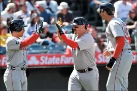  ?? AP PHOTO/ALEX GALLARDO ?? Boston Red Sox’s Masataka Yoshida, left, greets Reese McGuire, center, with Triston Casas, right, after McGuire hit a three-run home run against the Los Angeles Angels during the sixth inning of a baseball game in Anaheim, Calif., Sunday, April 7, 2024.