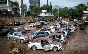  ??  ?? This general view shows damaged vehicles in a open parking area of northern Athens after a flash flood struck the Greek capital. The flood follows fires, which broke out in Greece on July 23, the deadliest in living memory. — AFP photo