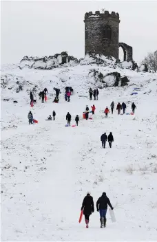  ?? Reuters ?? Visitors to Bradgate Park, near Leicester in England, go sledging to enjoy the snow as weather disruption continued