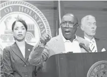  ?? Steve Gonzales / Houston Chronicle ?? Flanked by Councilmem­bers Amanda Edwards and Jack Christie, Mayor Sylvester Turner on Friday proposes a budget that uses one-time fixes, including selling city land, as well as layoffs to close an estimated $160 million budget gap.