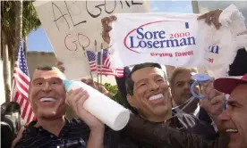  ?? Photograph: Marta Lavan ?? Men wearing Bush and Gore masks respective­ly rally in front of the Stephen P Clark Government Center in Miami on Wednesday 22 November 2000.