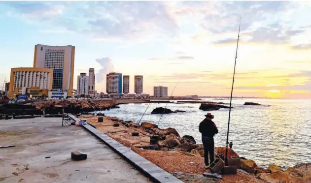  ?? Agence France-presse ?? ↑
A fisherman is pictured along the promenade in Libya’s capital Tripoli on Wednesday.