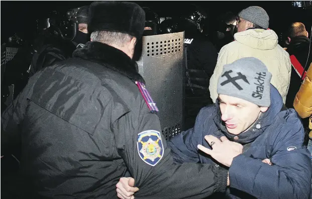  ?? Ale xander KHUDOTEPLY / AFP / Gety Images ?? Pro-Russian protesters clash with police as they try to storm the security service offices in Donetsk to free their arrested leadership Thursday.