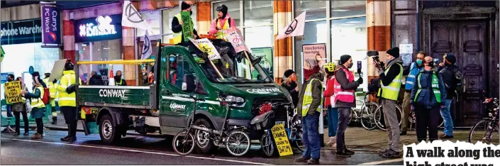 ??  ?? ROAD RAGE: Extinction Rebellion protesters try to stop council workers in Kensington High Street from ripping up the recently installed cycle lane bollards