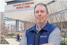  ?? PHOTO/SUE OGROCKI] ?? Dr. Cameron Mantor, Chief Medical Officer at OU Medicine, stands outside the hospital complex Thursday. Mantor said while vaccines hold promise, hope still seems dim as ICU cases keep mounting. [AP