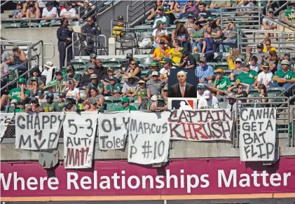  ?? D. ROSS CAMERON/ASSOCIATED PRESS ?? Athletics fans drape the bleachers with messages Sept. 22 against the Rangers in Oakland, Calif. Baseball players and owners are caught in a bitter dispute over how to start amid the coronaviru­s pandemic.