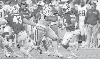  ?? Jonathan Daniel / Getty Images ?? LSU offensive lineman Josh Boutte (76) was ejected in the fourth quarter for his late hit on Wisconsin safety D’Cota Dixon, right, who sealed the Badgers’ 16-14 victory over the Tigers with an intercepti­on with 57 seconds left.