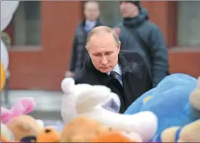  ?? ALEXEI DRUZHININ / KREMLIN VIA REUTERS ?? Russian President Vladimir Putin visits the site of the fire that killed at least 64 people, including 41 children, at a shopping mall, in Kemerovo, Russia, on Tuesday.
