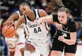  ?? Jessica Hill / Associated Press ?? UConn’s Aubrey Griffin (44) is fouled by Providence’s Meghan Huerter (3) on Dec. 2 in Storrs.