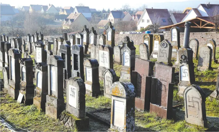  ?? (Reuters) ?? SWASTIKAS ON a graveyard in France.