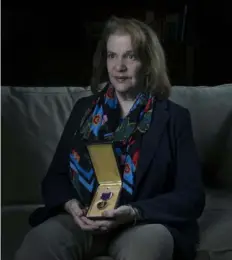  ?? Nate Guidry/Post-Gazette ?? Dr. Barbara Kasperko O’Connell at her home Friday in Fox Chapel. She holds the Purple Heart awarded to her late uncle Sgt. Joe Kasperko, radio operator and gunner on a B-17 aircraft shot down over Germany during WWII.
