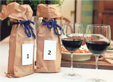  ?? ANGELA PETERSON / MILWAUKEE JOURNAL SENTINEL ?? Two Pinot Noirs, one French and one California, served in paper bags, let diners decide which they prefer without bias.