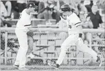  ?? MATHEW MCCARTHY WATERLOO REGION RECORD ?? Luke Baker, left, congratula­tes Kitchener Panthers teammate Mike Gordner for hitting a home run that helped eliminate the Toronto Maple Leafs at Jack Couch Park on Thursday night.