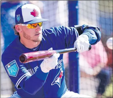  ?? FRANK GUNN/THE CANADIAN PRESS ?? Blue Jays’ Josh Donaldson, taking bunting practice at spring training yesterday, says he won’t discuss his contract extension during the season so he can concentrat­e on winning games.