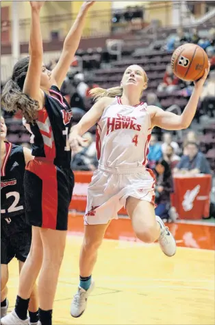  ?? KEITH GOSSE/THE TELEGRAM ?? The Memorial Sea-hawks Jane Baird (4) goes up for a shot against Jessica Dyck of the Winnipeg Wesmen during their game in the Marie’s Mini Mart Fall Classic Saturday afternoon at the MUN Field House.