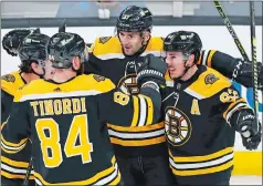  ?? MICHAEL DWYER/AP PHOTO ?? Patrice Bergeron of the Boston Bruins (37) celebrates his goal with teammates during the first period of Sunday’s game Washington Capitals in Boston. The Bruins won 6-3.