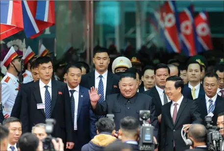  ??  ?? „ Mr Kim waves after arriving on his special train in Vietnam. His nuclear programme is on verge of being able to strike targets around world.