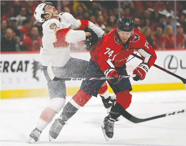  ?? PATRICK SMITH/GETTY IMAGES ?? Capitals defenceman John Carlson checks Florida winger Mason Marchment during Saturday's game at Capital One Arena in Washington. The Caps defeated the heavily-favoured Panthers 6-1 to take a 2-1 lead in the best-of-seven first-round Eastern Conference series.