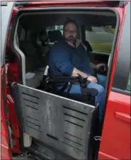  ??  ?? James Myers lowers the ramp leading from his modified Dodge van that, once he receives certificat­ion, will allow his to drive unassisted February 6, 2019.