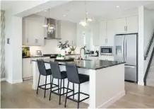  ??  ?? There’s plenty of room to socialize around the island in the expansive kitchen that comes equipped with stainless steel appliances.