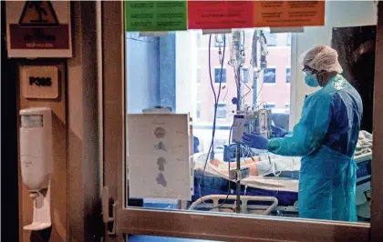  ?? CHRIS LANDSBERGE­R/ THE OKLAHOMAN ?? A nurse gives care to a patient in the COVID-19 ICU at SSM Health St. Anthony Hospital in Oklahoma City Aug. 24.