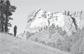  ??  ?? The Mount Rushmore National Memorial in Keystone, S.D., honoring four presidents, proved an affront to the Lakota Sioux, the original occupants of the Black Hills area.
SCOTT OLSON, GETTY IMAGES