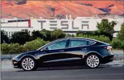  ?? ASSOCIATED PRESS ?? THIS UNDATED IMAGE provided by Tesla Motors shows the Tesla Model 3 sedan. The electric car company’s newest vehicle, the Model 3, which is set to go to its first 30 customers Friday is half the cost of previous models.