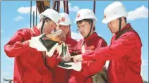  ?? REN QI / CHINA DAILY ?? Workers test samples at an oil field in Aktobe, Kazakhstan.