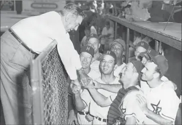  ?? Los Angeles Times ?? BOB COBB, a restaurate­ur and team president at one time, congratula­tes the Hollywood Stars after their 1953 Pacific Coast League title. Bing Crosby and Gary Cooper, among several celebritie­s, were part-owners.