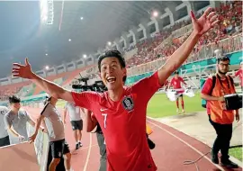  ??  ?? Son Heung-min celebrates South Korea’s Asian Games gold medal, which means he is now exempt from military service.