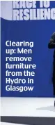  ?? ?? Clearing up: Men remove furniture from the Hydro in Glasgow