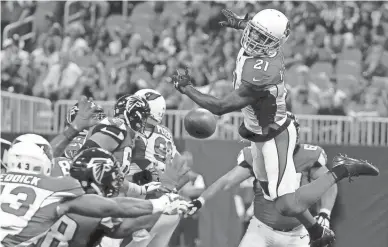  ?? DAVID GOLDMAN/AP ?? Cardinals cornerback Patrick Peterson (21) jumps for a Falcons pass during the first half of a preseason game on Saturday in Atlanta.