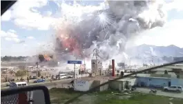  ??  ?? This image made from a video recorded from a passing car shows an explosion ripping through the San Pablito fireworks’ market in Mexico, on Tuesday.