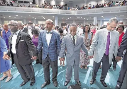  ?? PHOTOS BY JIM WEBER/THE COMMERCIAL APPEAL ?? Brown Missionary Baptist Church’s new Disciplesh­ip Pastor Wade Steelman (right) joins fellow pastors Marquis Gooden (second from right) and Bartholome­w Orr (second from left) in prayer during Sunday service at the church’s Swinnea Road campus. Steelman...