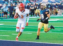  ?? JOSH DAFOE FOR THE U-T ?? Marcus Ratcliffe of Cathedral Catholic hits paydirt at the end of his TD reception against Mater Dei in the No. 1 Dons' victory over No. 3 Crusaders on Saturday.
