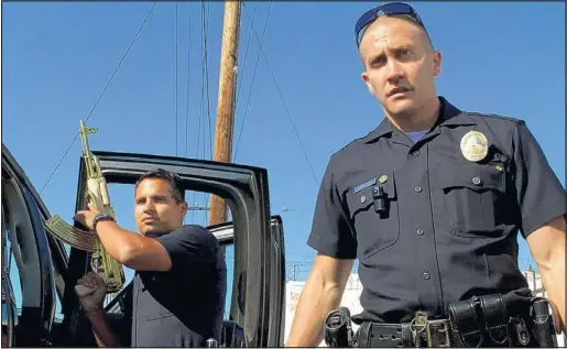  ??  ?? Michael Peña, left, and Jake Gyllenhaal play cops who go after a drug cartel in Los Angeles in “End of Watch.”