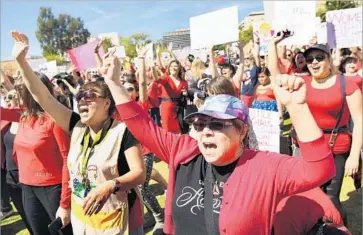  ?? Wally Skalij Los Angeles Times ?? IN DOWNTOWN LOS ANGELES, people take part in “A Day Without A Woman” rally. In Washington, House Minority Leader Nancy Pelosi told protesters, “When women succeed, the world succeeds.”