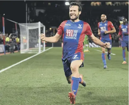  ??  ?? 2 Yohan Cabaye runs to take the acclaim of the Crystal Palace fans after scoring the second goal in their 3-0 defeat of Arsenal last night.