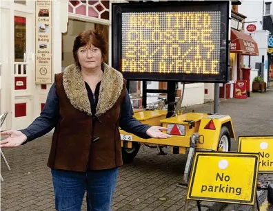  ??  ?? Angry: Mrs Fleming says this sign was the first villagers knew of the works. Below, the detour